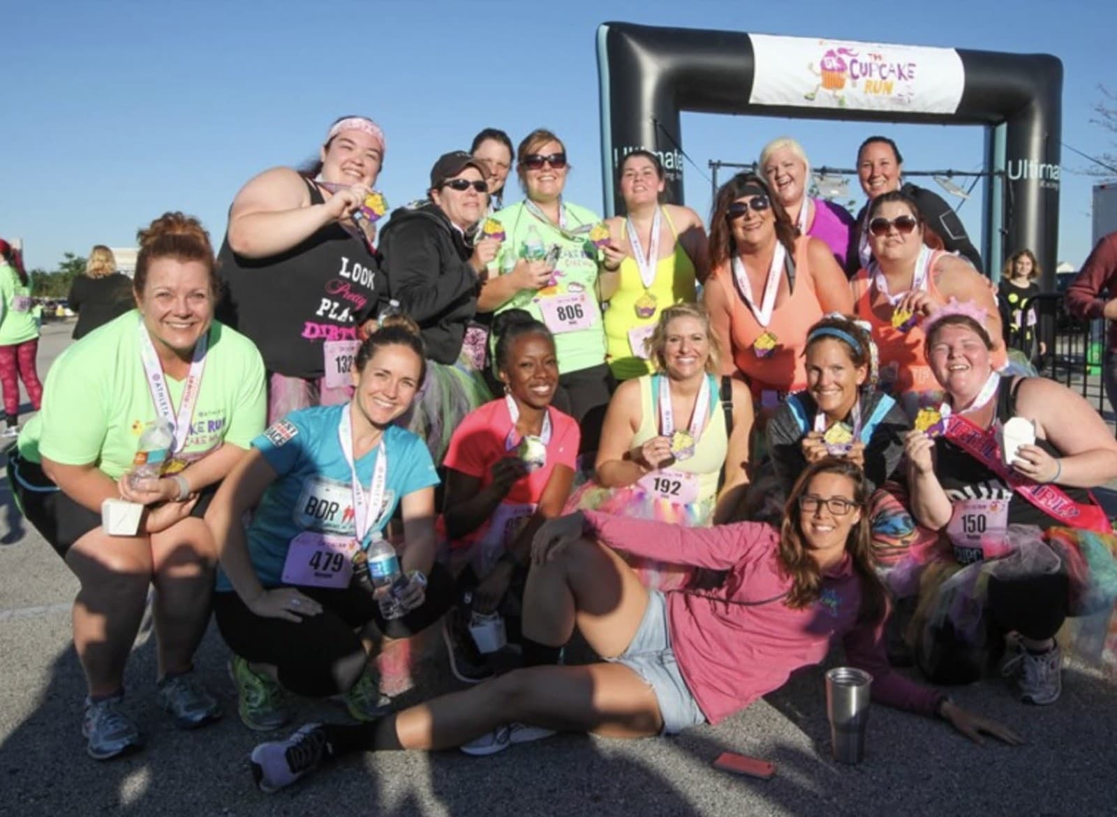 Runners posing with medals at the Cupcake Run