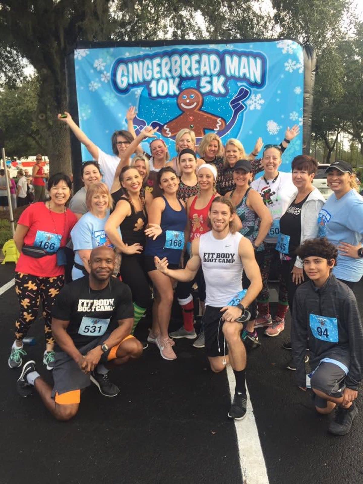 A large group of race finishers smiling together for a photo