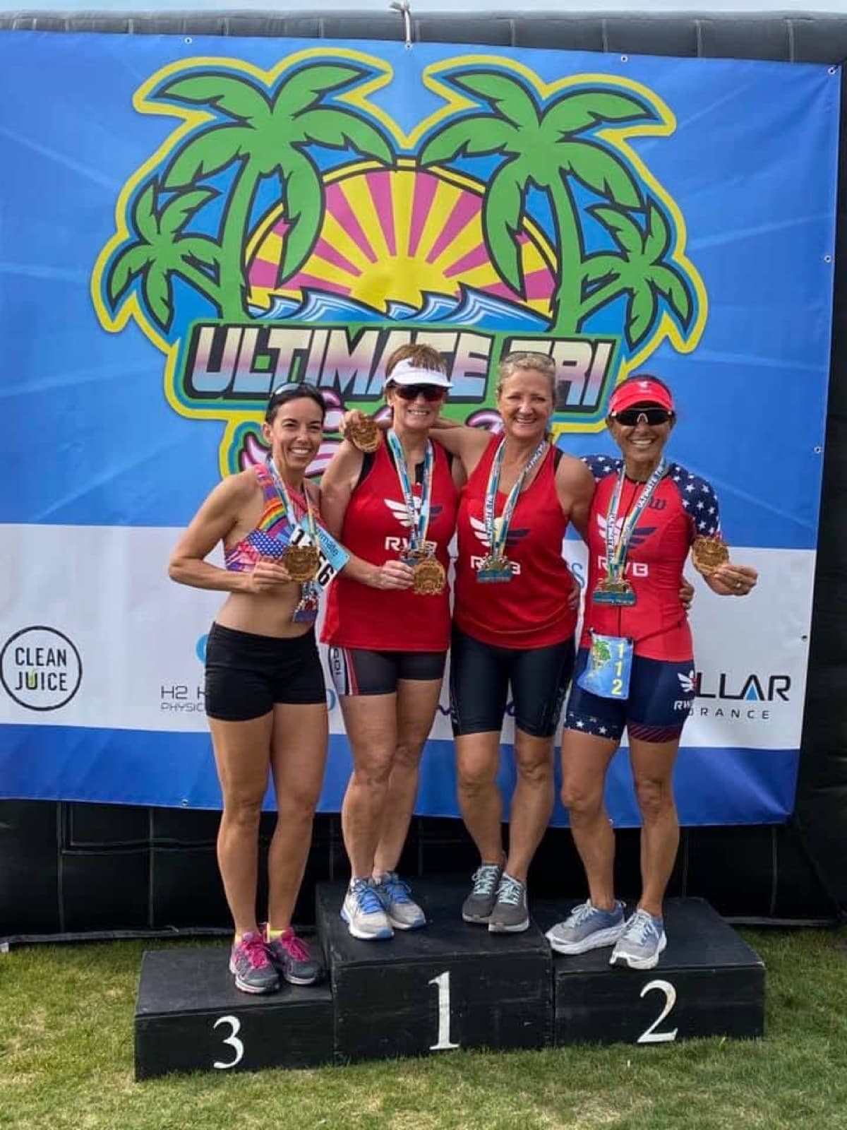 Athletes celebrating on an awards podium at a multisport event