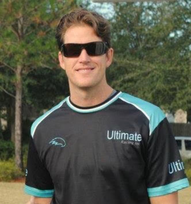 Sal Palmieri smiling in sunglasses, wearing an Ultimate Racing polo.