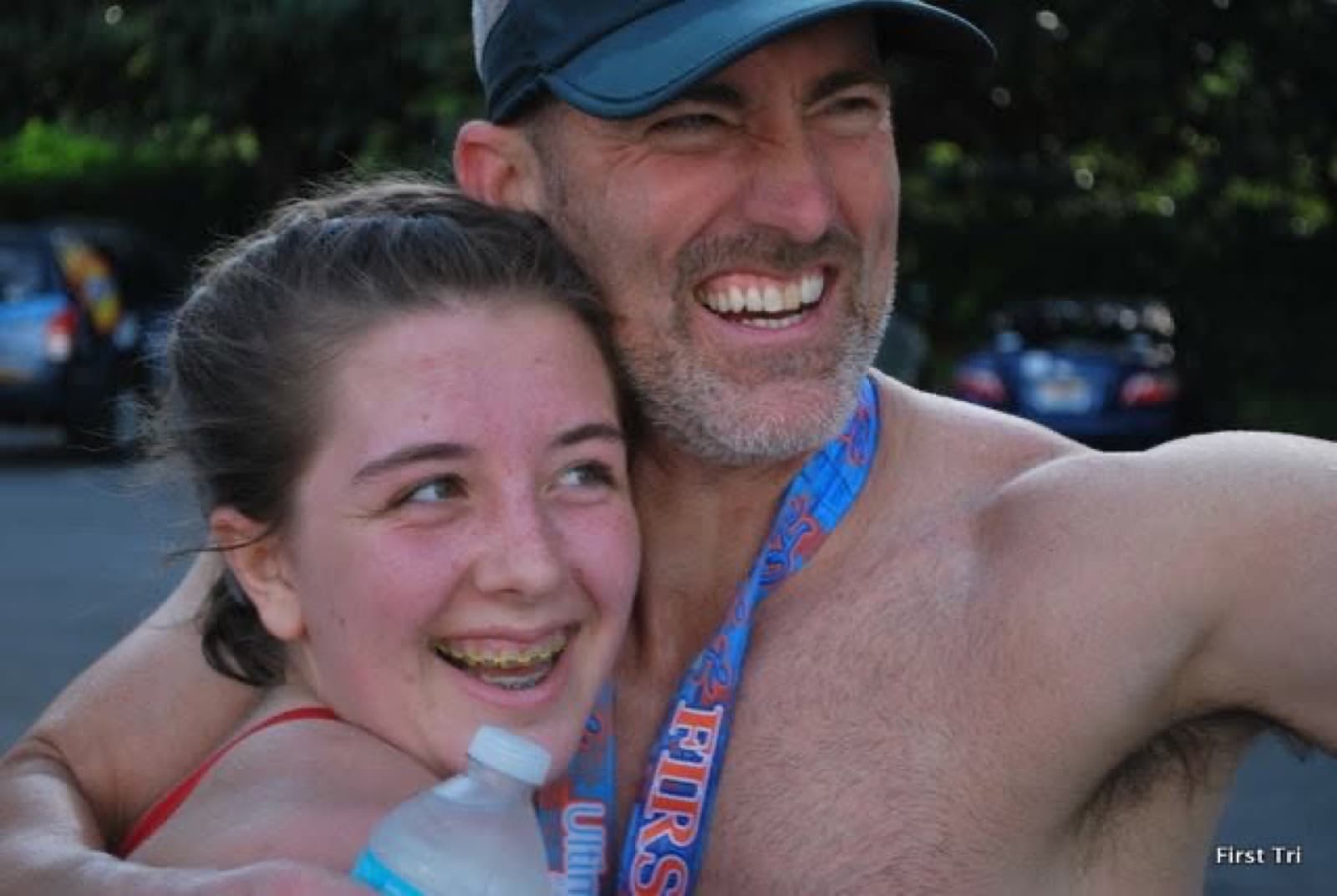 An adult and child together at a triathlon